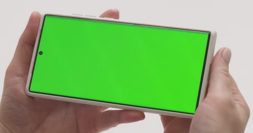 Closeup of Woman Hands Holding Smartphone with Green Screen