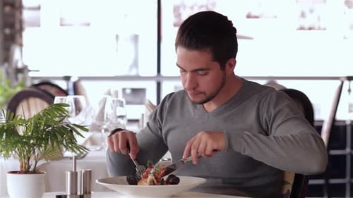 Man Enjoys Seafood Meal in Upscale Restaurant