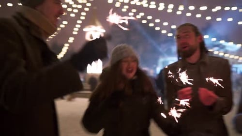 Friends Have Fun Partying with Sparklers and Explode Confetti Cannon at Christmas Market Cheerful