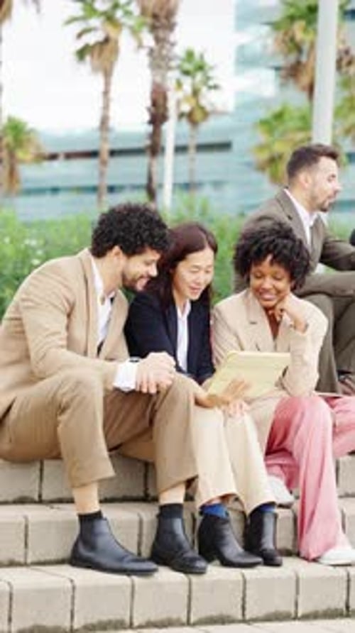 Business People Having Meeting Using Tablet Outside