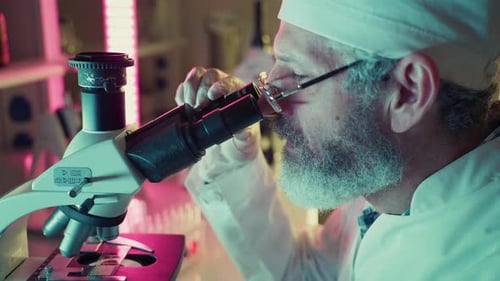 Wissenschaftler analysieren Probe mit Mikroskop im Labor