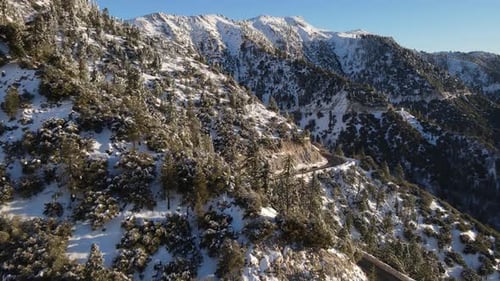 Aerial of a road through the mountains after a snow