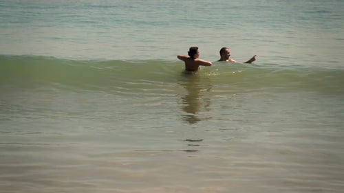 Young couple talking and relaxing in super slow motion at the sea on summer vacation