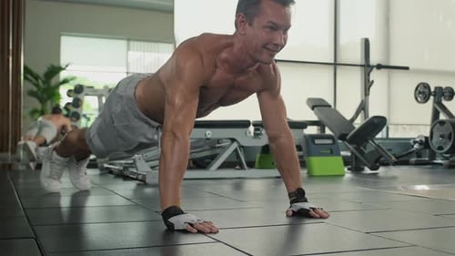 Athletic Man Doing Push-Ups in Gym