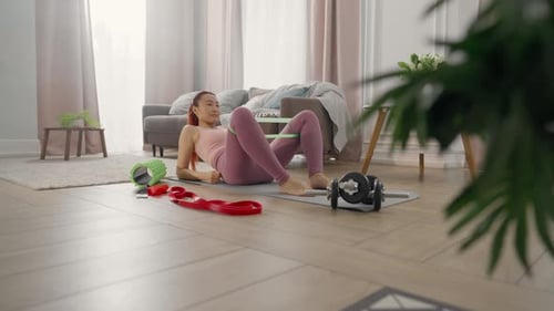 Woman Exercising with Elastic Band at Home