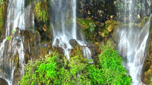 Beautiful waterfall in a tropical forest by aerial view from a drone.