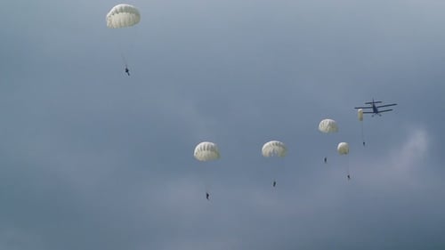 Skydivers Jumping From Plane with Parachutes in Open Sky