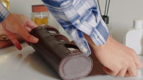 Man Opens Leather Watch Case and Removes Watch