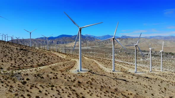 Dramatic rise and fly in to close up of spinning blades of windmill ...