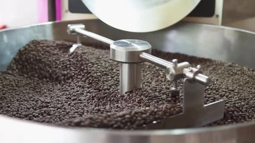 Coffee Beans Stirred in a Stainless Steel Container