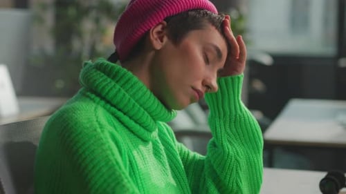 Tired Person Wearing Colorful Attire Focusing Amidst Tranquil Workspace Environment to Manage Stress