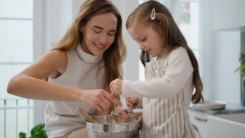Mother and Daughter Baking Together in a Kitchen