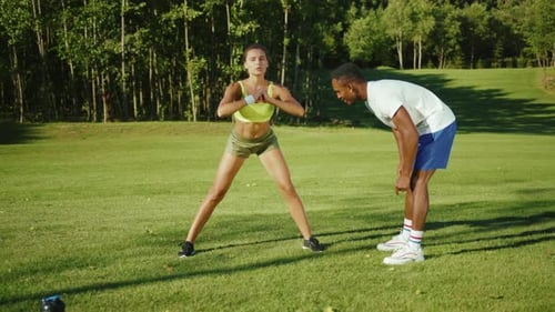 Caucasian Active Beautiful Woman Doing Stretching Squats Cardio Exercises on Warmup Session with