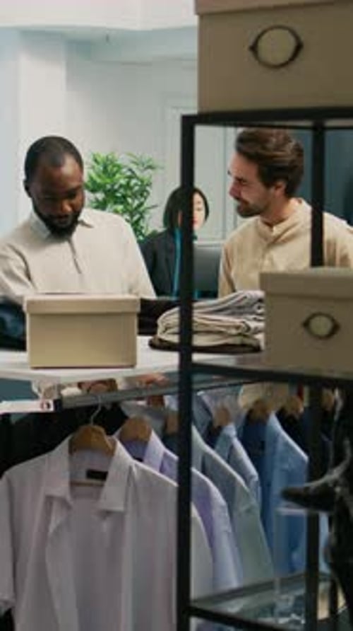 Vertical Video Male Customer Examining New Merchandise on Shop