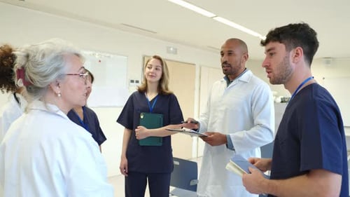 Medical Team Discussing Patient Cases in Hospital Meeting