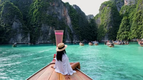 Women in Front of Longtail Boat at the Lagoon of Koh Phi Phi Thailand