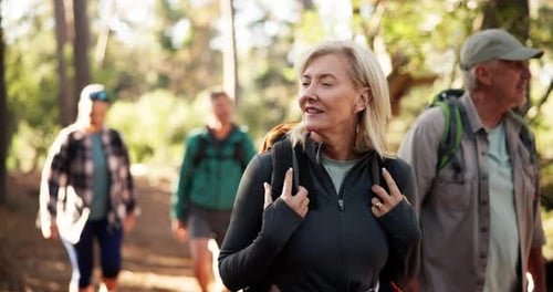 Hiking, woman and group in woods, walking and journey for backpacking in environment and adventure