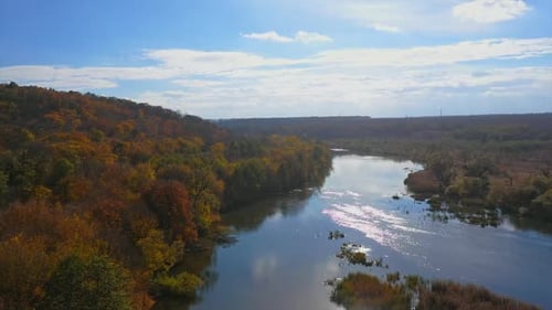 Stunning river and forest in autumn. Flying over the river and forest during autumn