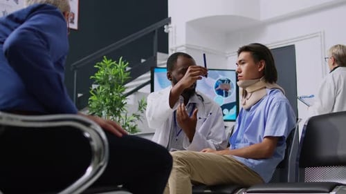 Doctor Explains Diagnosis to Patient Wearing Neck Brace