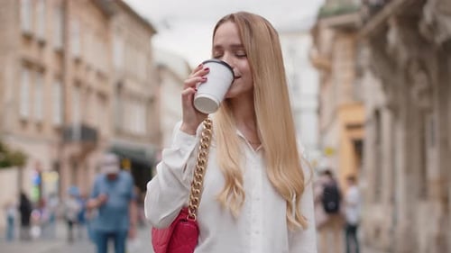 Happy Woman Girl Enjoying Drinking Morning Coffee Hot Drink Relaxing Taking a Break in City Street