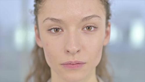 Close Up of Serious Young Woman Looking at Camera