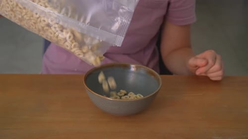 Close Up Woman Pouring Corn Flakes Into Plate with Clear Sound Preparing Breakfast at Home Food