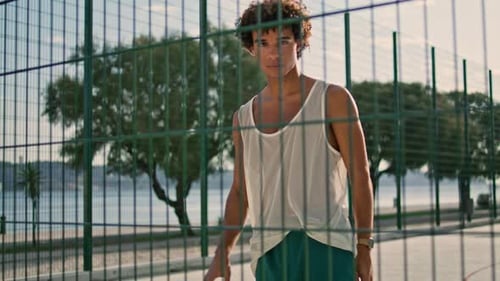 Modern Sportsman Playing Basketball on Sports Field Portrait. Skilful Teenager Kicks Ball
