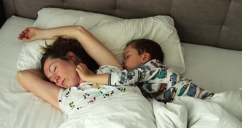 Mother and Child Sleep Comfortably in Bed