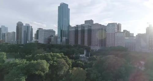 A breathtaking view of Chicago's skyline, with towering skyscrapers contrasting with the lush greene