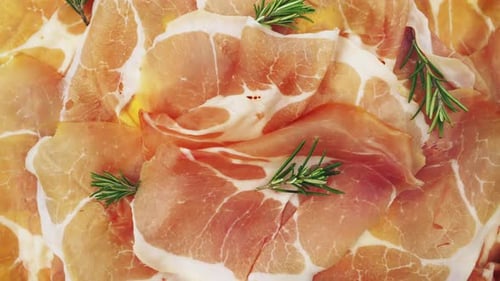 Close Up of Sliced Cured Meat with Rosemary