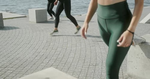 Woman Exercising with Group on Quay