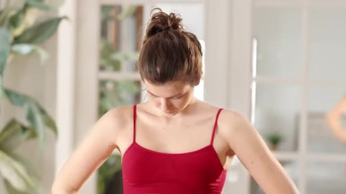Woman Stretching Neck Muscles in Bright Room