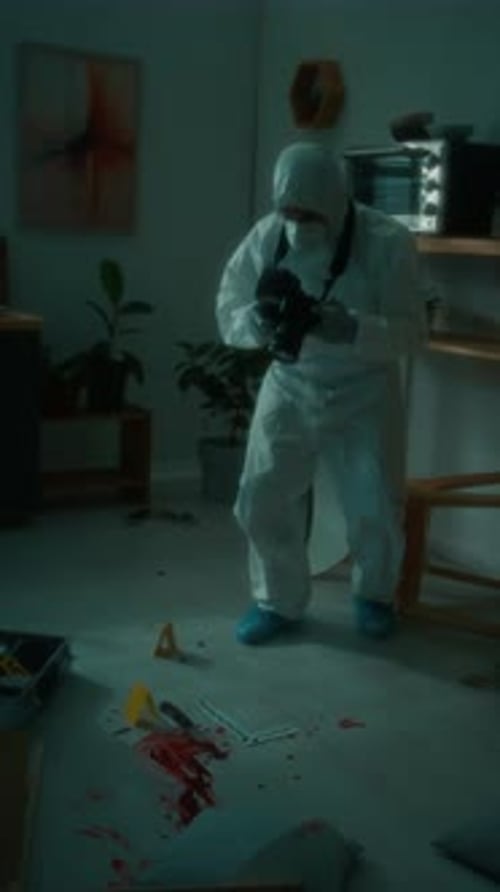 Forensic Photographer Taking Pictures of Blood Pool and Knife
