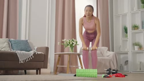 Young Woman Lifting Weights During Home Workout