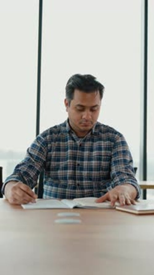 Indian Student Sits in Library Prepare for Exam and Making Notes in Notebook Vertical Video