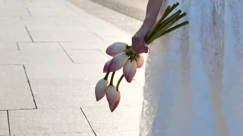 Newlyweds Walking With Bouquet After Wedding on City Street