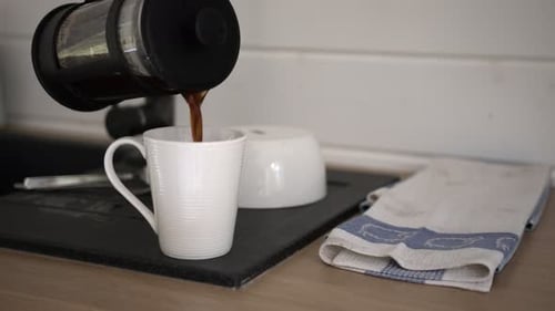 Pouring Coffee from French Press into Mug