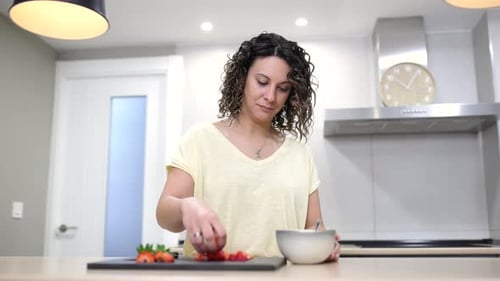 Woman Preparing Strawberries in Bright Modern Kitchen