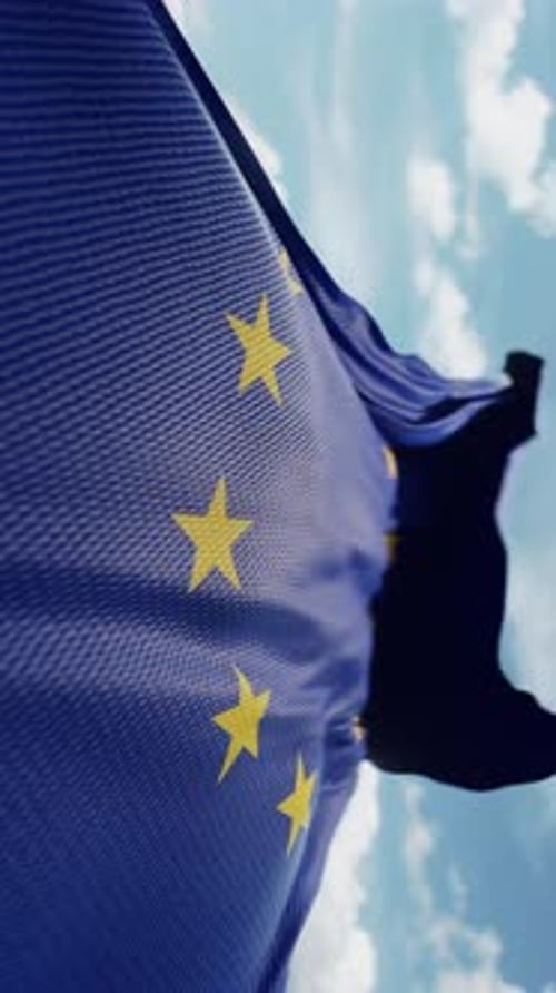European Union Flag Waving Against Blue Sky Loop