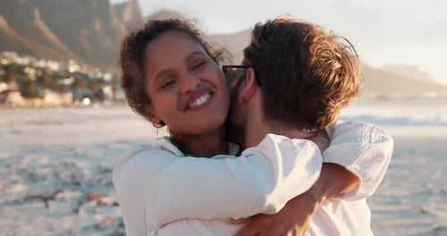 Young Couple Embracing on Beach at Sunset