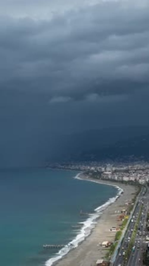 Vertical Video Aerial Alert Beautiful Mediterranean Coastline and Cityscape Amidst Storm Warning