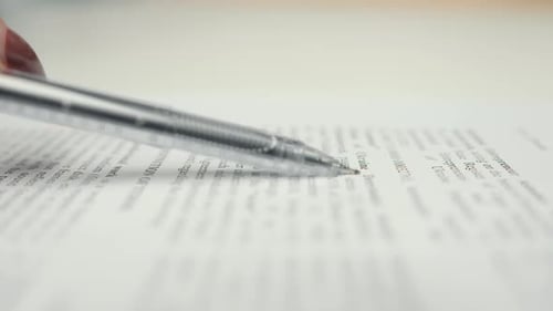 Close-up: woman lawyer office worker proofreading a contract before signing