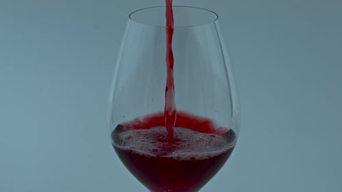 Pouring Red Wine into a Wine Glass