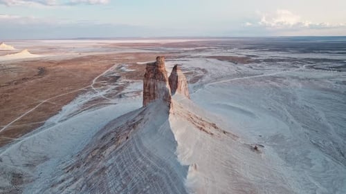 Experience a Breathtaking Aerial View of Majestic Rock Formations in a Captivating Desert