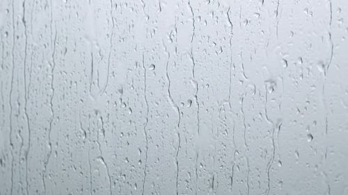 Rain Drops Dripping Down Window Pane