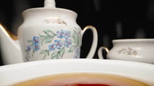 Tea drinking, I pour sugar from a spoon into a cup. Slow motion, Dolly slider extreme close-up. Laow