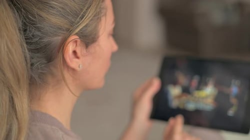 Woman watching movies on a tablet at home