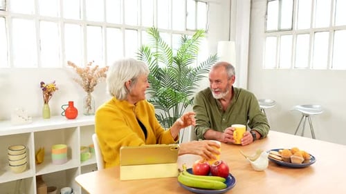 Senior Couple Enjoying a Healthy Breakfast in the Living Room