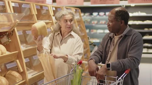 Married Couple Choosing Loaf Of Bread