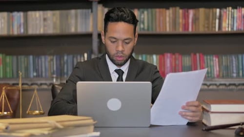 Young Adult Lawyer Works in Classic Office Setting